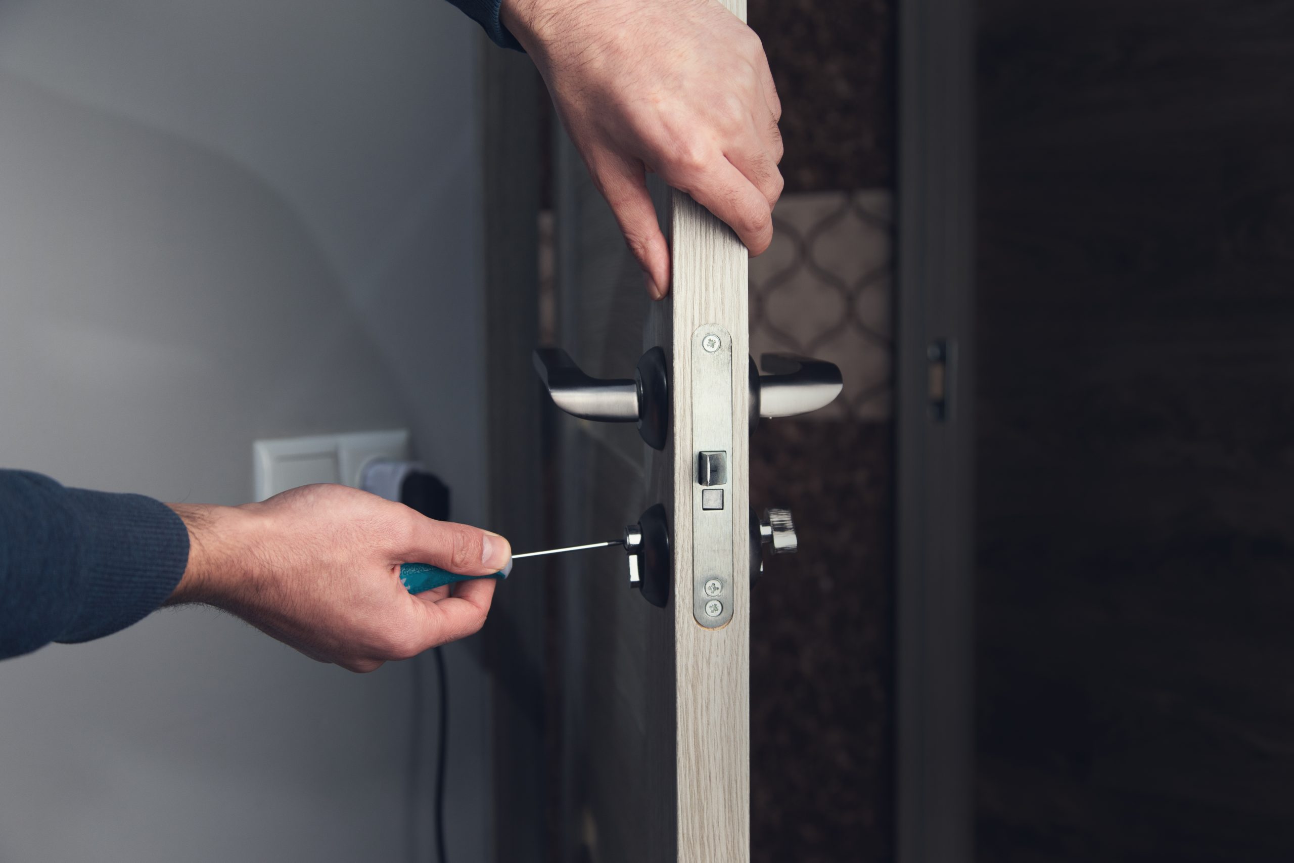 Commercial door lock being repaired in a business building showing worn internal mechanism